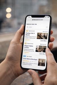 Mobile view of salon search results showing sponsored listings and verified salon reviews.