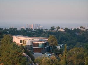 Aerial view of the entrance to the 2423 Briarcrest Residence, showing the approach from above with the Century City skyline in the background.
