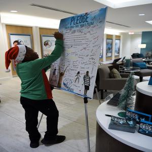 Over 100 kids signed the pledge to live drug-free for good at the Christmas Village Party on December 22nd. Shown here is a young man in the Foundation for a Drug-Free World Florida center, one of the 8 humanitarian centers participating in the Christmas Village event.