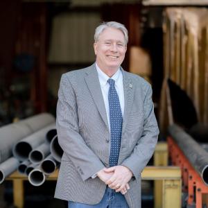 John C. Gooden, COO of M. Davis, standing at a fabrication shop