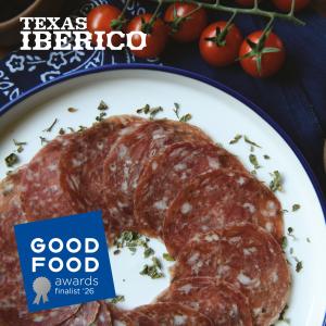Sliced Texas Iberico Mesa Salami arranged on a white plate with Mexican oregano, shown with a 2026 Good Food Awards finalist badge.