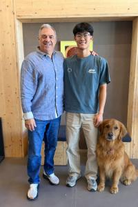 a teacher and high school student with dog