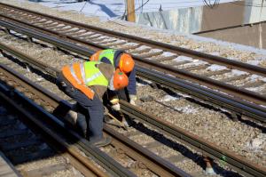 Workers use the TESCO Third Rail Voltage Detector