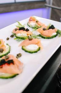 Smoked salmon on cucumber rounds with herbed cream cheese, capers, fresh dill, and caviar, one of four elegant winter appetizers Chef Serge Krikorian demonstrated on THV11's The Vine. Photo by Vibrant Occasions Catering.