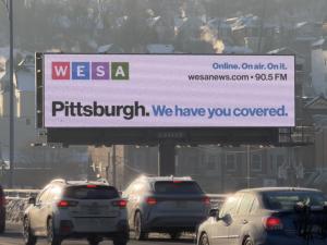 One of many billboards around Pittsburgh presenting WESA news headlines.