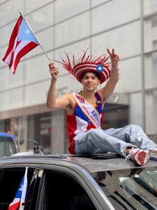 Señor Edison, honored as Social Media Ambassador, rides his official parade car at the 2025 Puerto Rican Day Parade. 