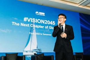 Globevisa CEO Henry Fan speaking on stage at GGCC 2025 in Singapore, presenting the #Vision2045 initiative with a large screen displaying "The Next Chapter of Global Citizenship".