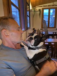 A dog kissing a man in Paris