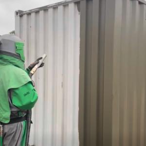 Sand blasting of shipping container to remove paint and to prep surface