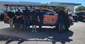 Technician fixing an automatic driveway gate motor and sensor alignment in Las Vegas.