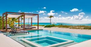The pool and beach view from Vision Beach villa in  Turks and Caicos