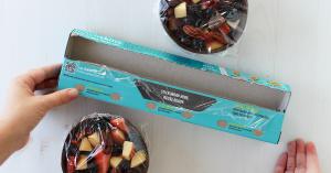 Lunchskins home compostable clear food wrap packaging displayed in a kitchen setting, now available at Sprouts Farmers Market.