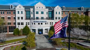 Front exterior view of the South Carolina Governor’s School for Science & Mathematics campus in Hartsville, with the main academic building centered and U.S. and South Carolina flags visible in the foreground.