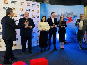 A person positioned in the middle of a group on stage receives an award at the ChannelNext Gala, representing ProServeIT’s leadership in managed IT services.