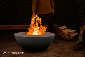 Firegear LUME Surround in the color Raven. A wood-burning fire feature with a metal smokeless fire pit inside a GFRC enclosure.