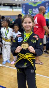 An athlete displaying her gold medal