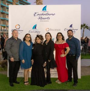 People posing at Encantame Resort's red carpet event