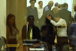 Armenian Archbishop Bagrat Galstanyan hugs his lawyer during a court appearance