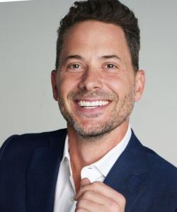 a smiling male executive in a blue suit