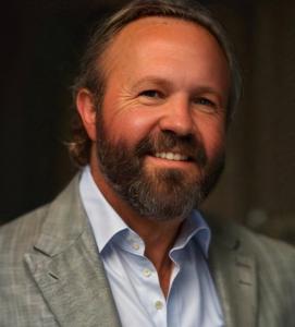 a smiling male executive in a gray suit
