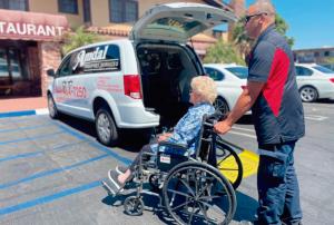 Amdal Transport Services staff assisting a client with wheelchair transportation in Tulare County, California