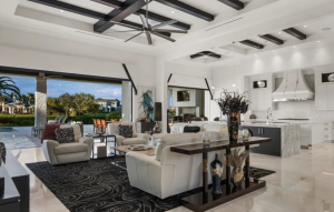 Interior view of a great room and gourmet kitchen featuring custom built-ins and dual islands.