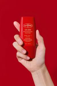 Red bottle of ALADDIN RX DA500 Barrier Protection Sun Cream, a clinical K-beauty sunscreen selected for Cosmo Trends 2026 at Cosmoprof North America Miami.