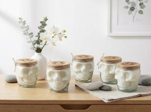 5 pure white and clear glass candles on a wood table top