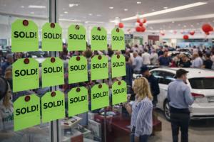 Car dealership showroom filled with buyers and sold tags during a Willowood Ventures Facebook Sales Event generating automotive leads and subprime leads