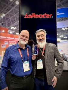 two men from AsReader holding award at tradeshow booth