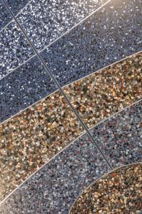 Irregular bands of terrazzo in blue and tan represent water, banks, and dunes.