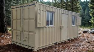 20ft prefab shipping container cabin with a steel door and window shutters