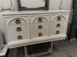 Details that inspire. A nine-drawer dresser with architectural moldings and antique bronze hardware, transformed into a pristine white that brightens any room.