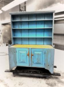 A touch of nostalgia. This country-style hutch features a distressed sky blue finish, open display shelves, and lower cabinet storage. A piece that tells stories.