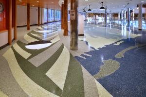 terrazzo in the college amphitorium depicts stylized imagery of sweetgrass in shades of green, with phases of the moon superimposed.