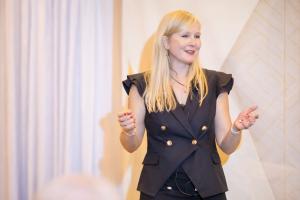 Dr. Kathryn Alderman delivering a keynote presentation on structured AI adoption in dentistry, outlining measurable performance benchmarks, compliance safeguards, and revenue optimization strategy.