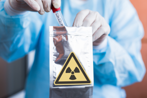 Technician using ¹⁴C-radiolabeled investigational products