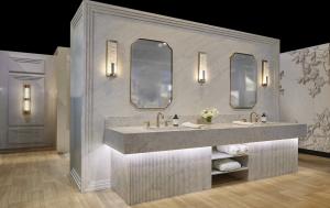 Cambria's spa bath at the 2026 KBIS Show, featuring natural quartz designs St. Isley™ (bold movement with blue-gray veining and warm undertones) and Traymore Bay™ (balanced warm-cool tones with organic depth)