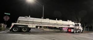 The Grease Company truck collecting used cooking oil from a commercial kitchen in Southern California.