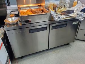 Commercial kitchen fryer with hot cooking oil, illustrating the source of used cooking oil and beef tallow waste.
