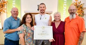 Graduate BA with his family