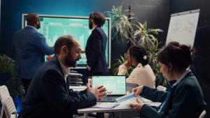 Business professionals collaborate on campaign strategy and performance analysis during a marketing planning session.