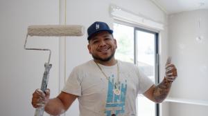 A professional painting smiling for the camera for That 1 Painter.