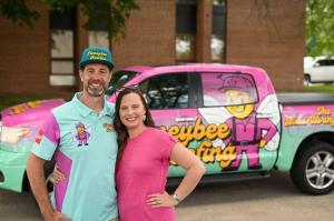 Owners of Local Roofing Company Standing in Front of an Attractively Branded Truck