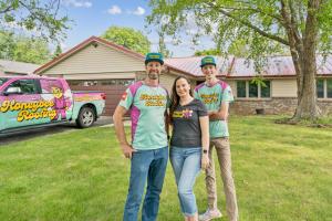 Metal Roofing in Rockford, IL - Team Members Standing in Front of Home With A New Metal Roof