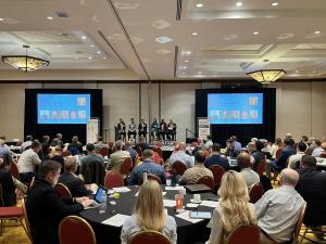 Event attendees watch presentation in conference ballroom