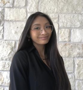 Photo of Katelyn Huffman in front of a stone wall.