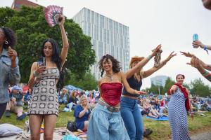 three young people dancing in front of the stage during the day at Waterfront Blues Festival