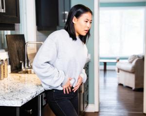 Woman holding pelvic area in pain