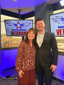 Female and male in photo in a broadcast studio. Female is Paula Pedene,podcast host. Male is Clifton Orlandi Spencers President.